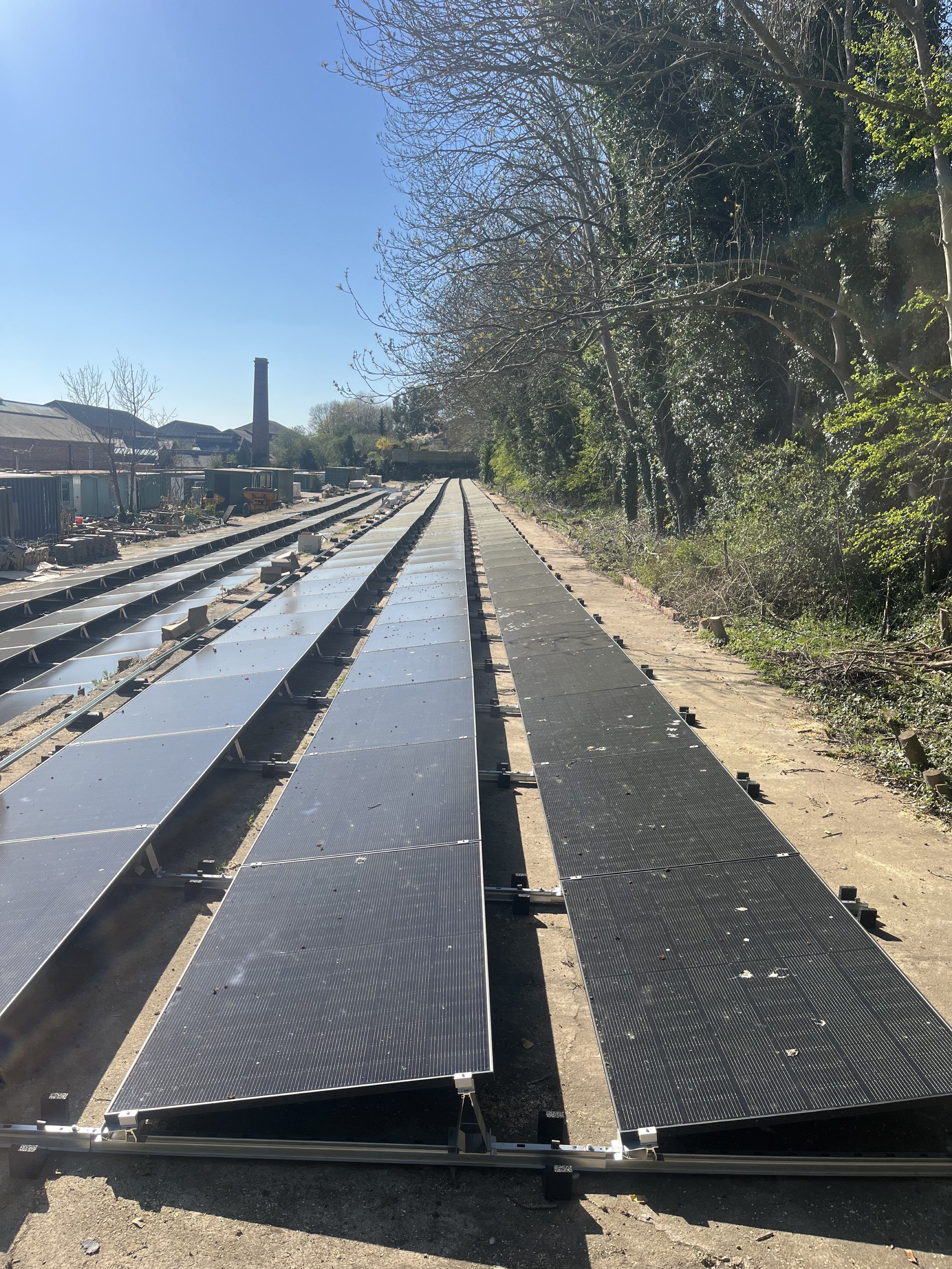 Ground-mount solar panel array installation at a commercial retail site