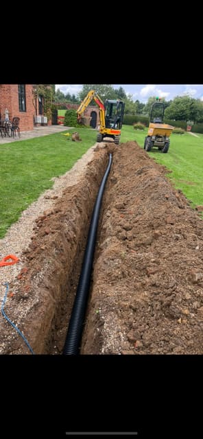 Twinwall cable ducting being installed in a trench at Seckford Hall