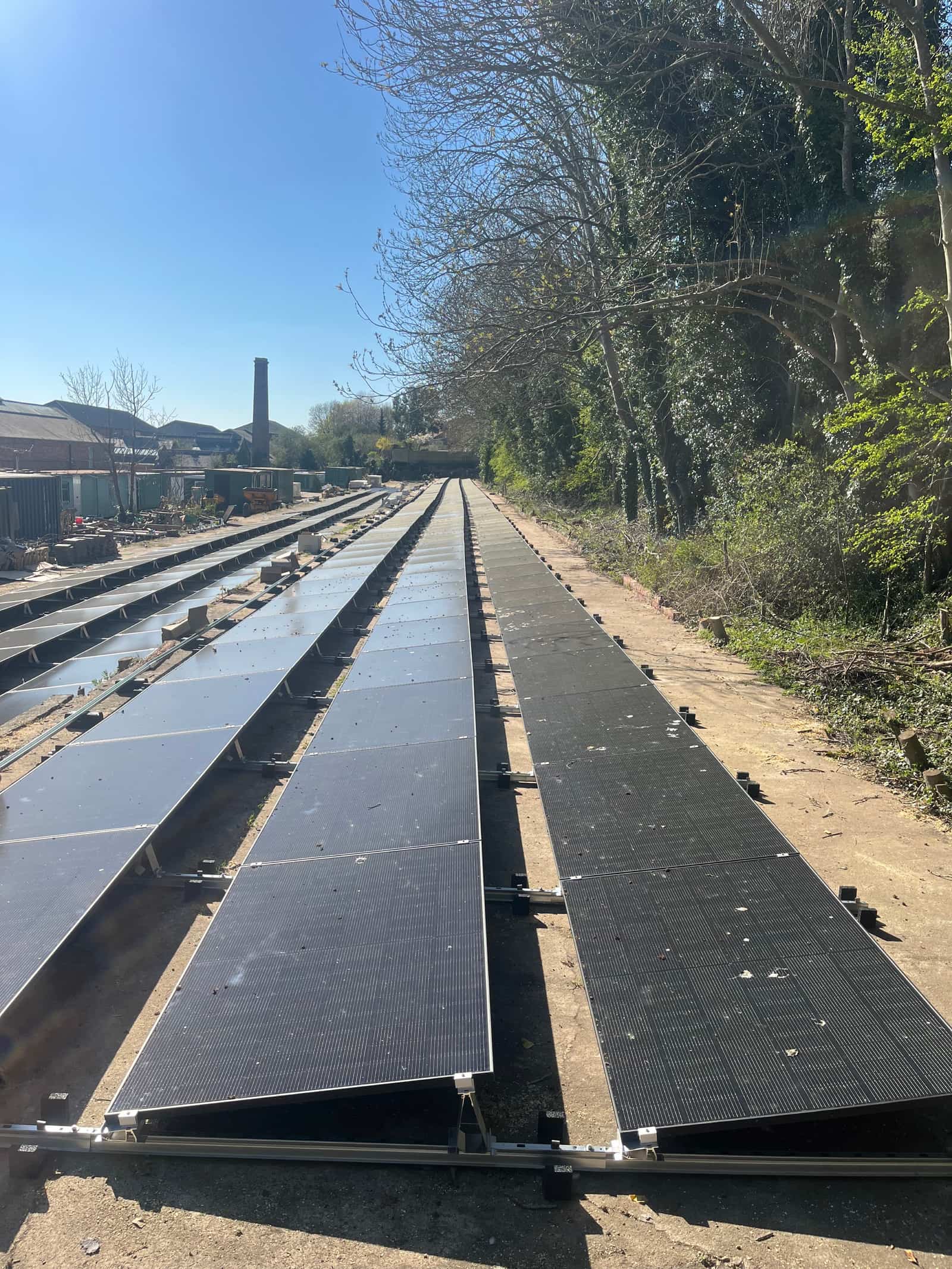 Rows of ground-mounted solar panels following the natural terrain at The Old Depot